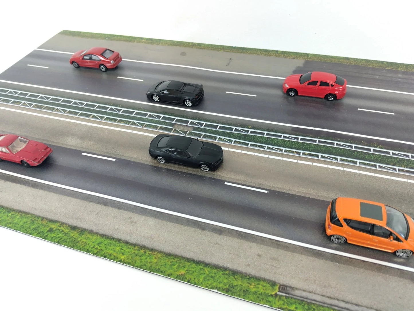 Model of a highway with cars on a white background
