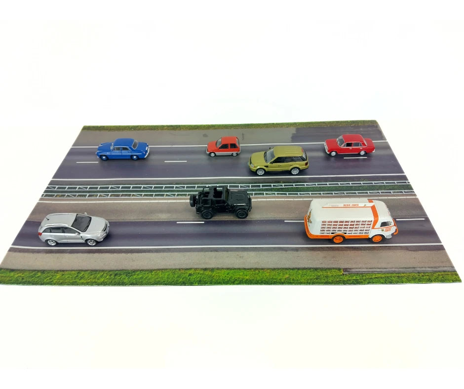 Model cars on a miniature road with a white background