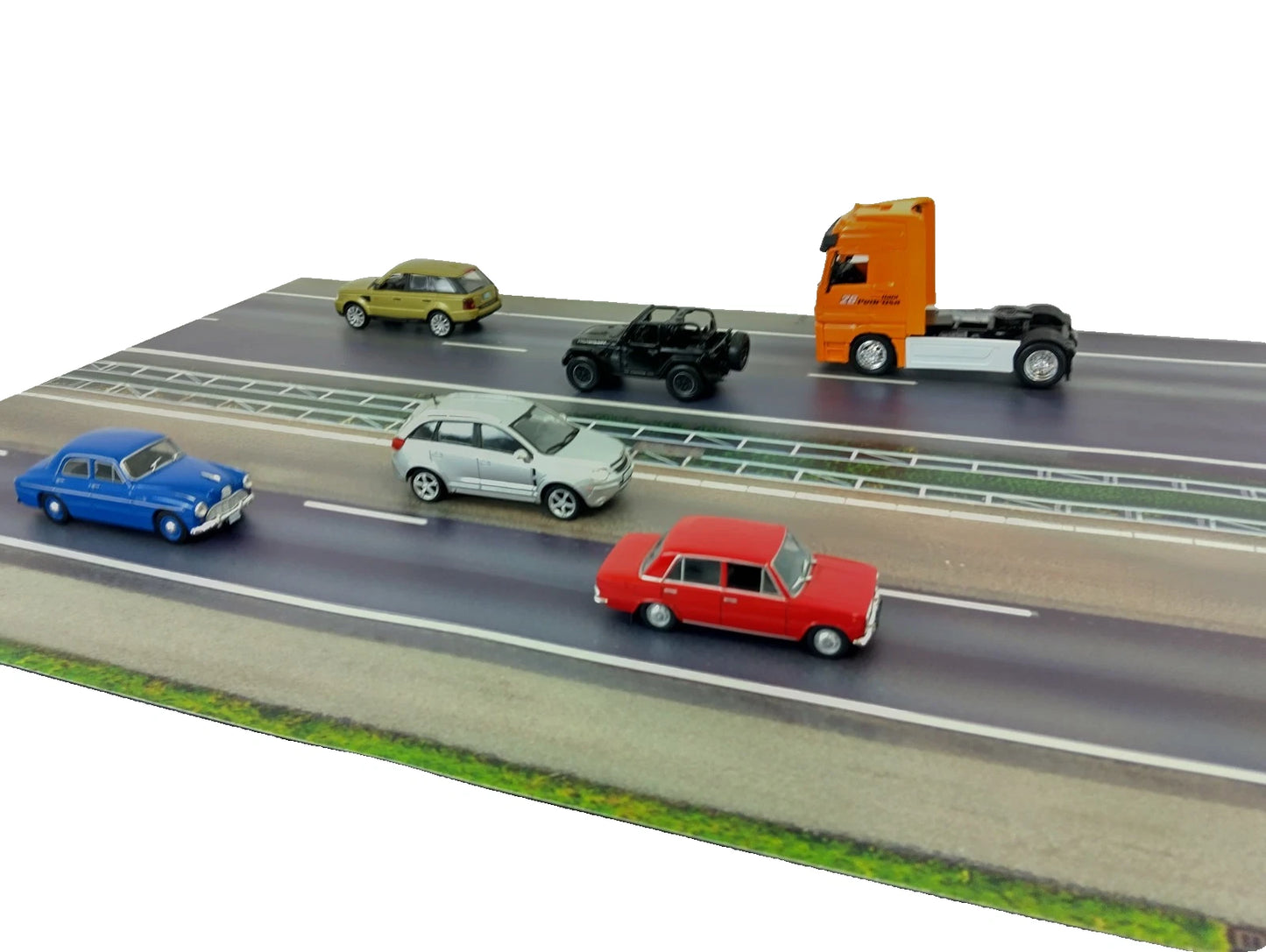 Model cars on a miniature road with a white background