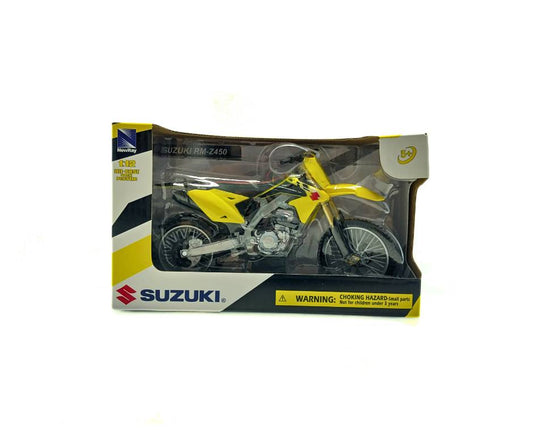 Yellow Suzuki motorcycle model in packaging on a white background
