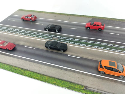 Model of a highway with cars on a white background