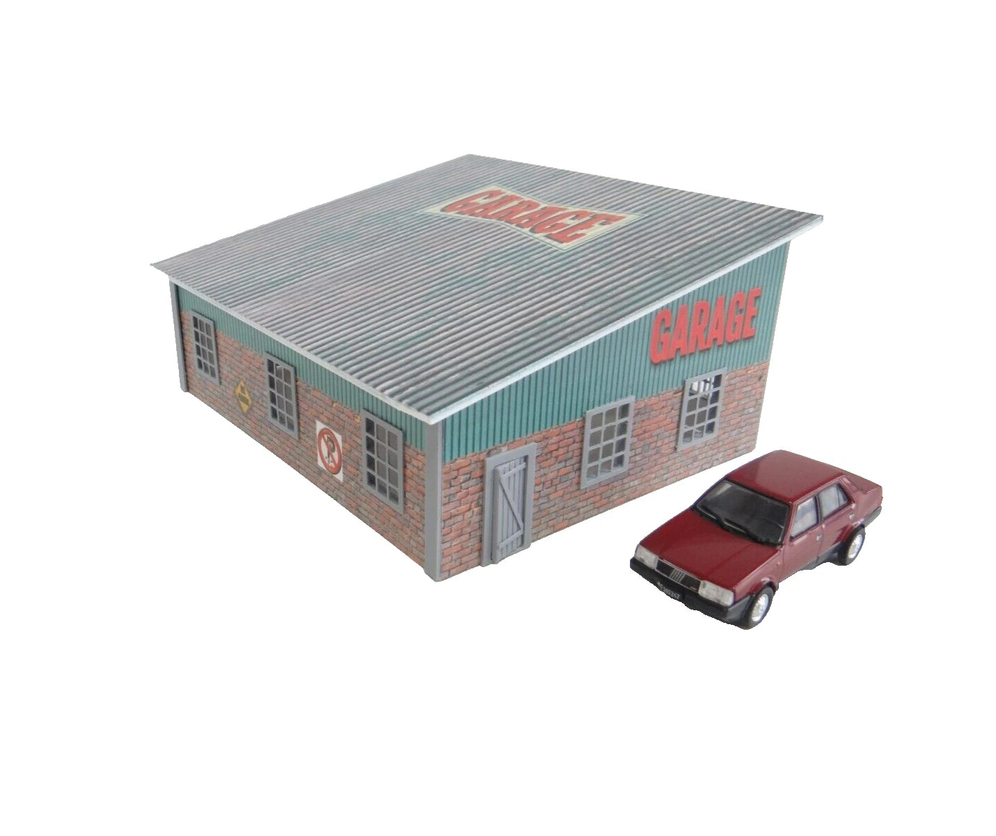 Model garage with a red car in front on a white background