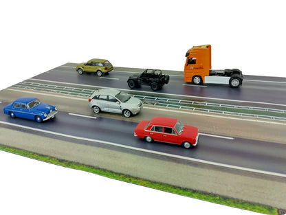Model cars on a miniature road with a white background