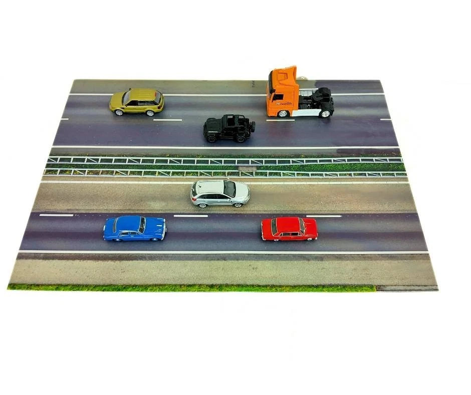 Model of a road with toy cars on a white background