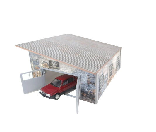 Model of a garage with a red car inside.